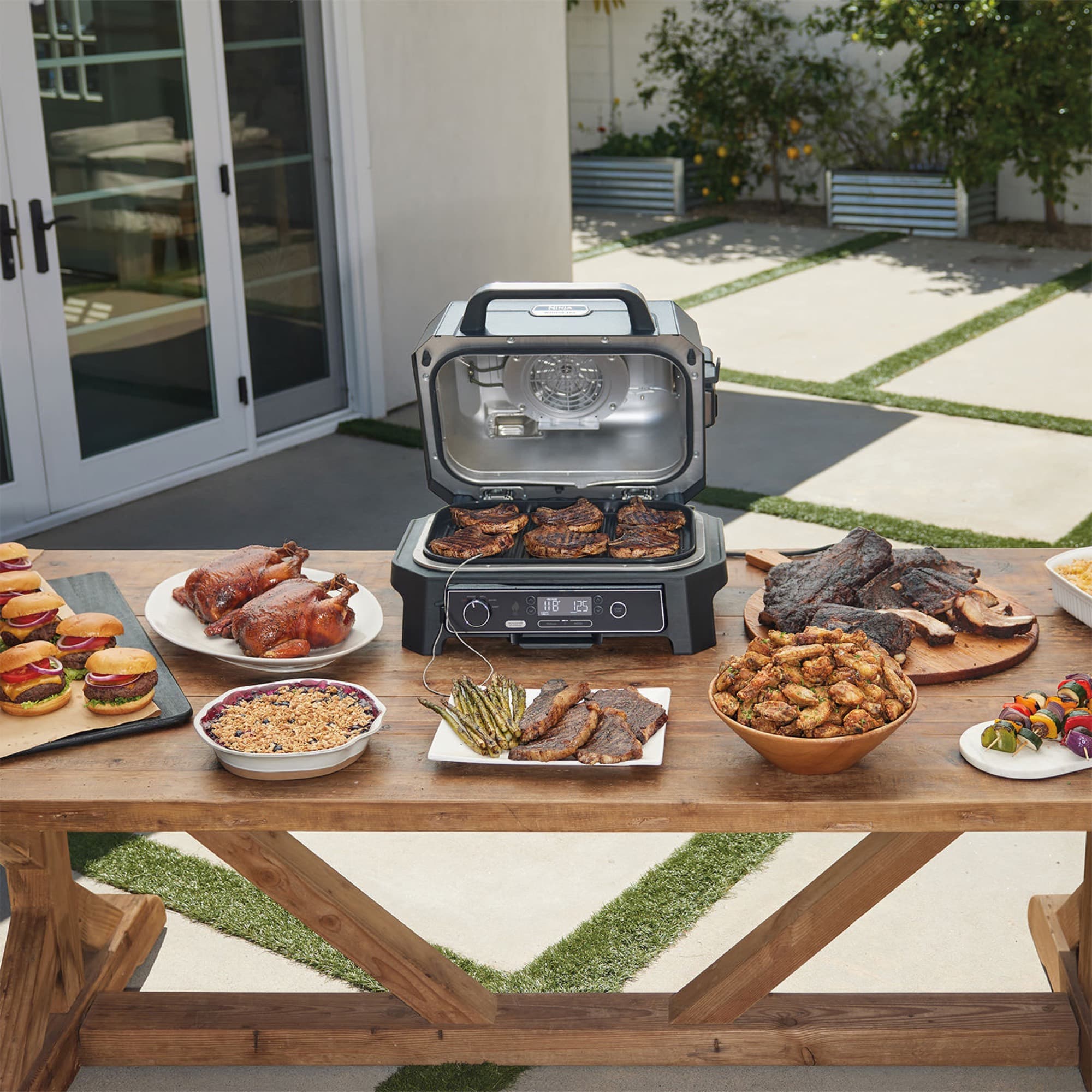 The grill on an outdoor table with grilled food