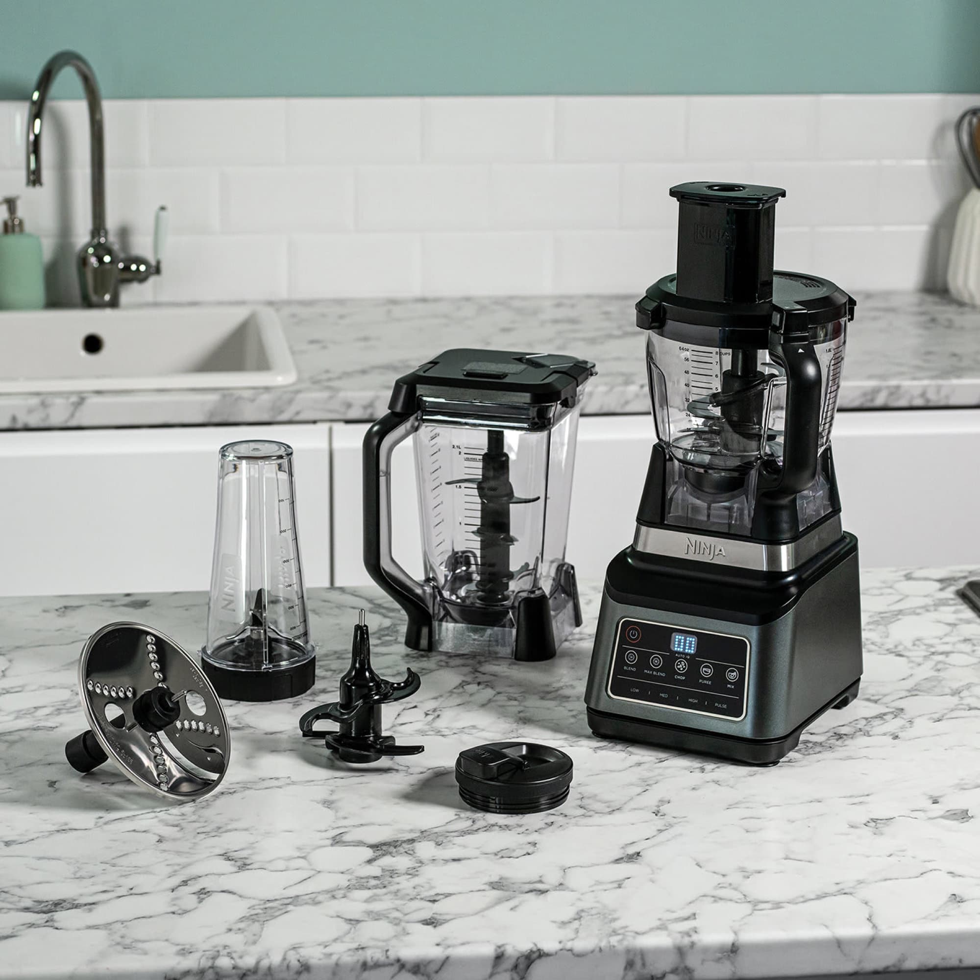 The food processor on the worktop with accessories