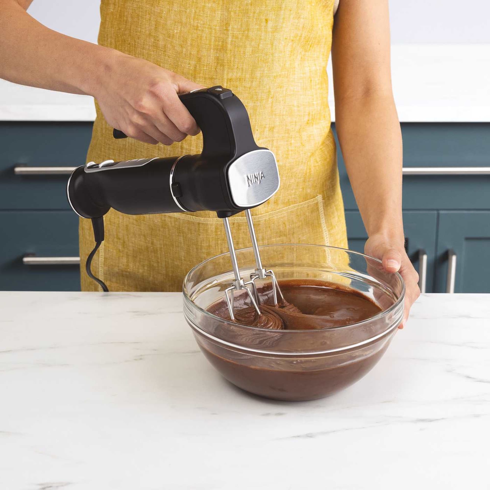 The hand mixer in chocolate batter