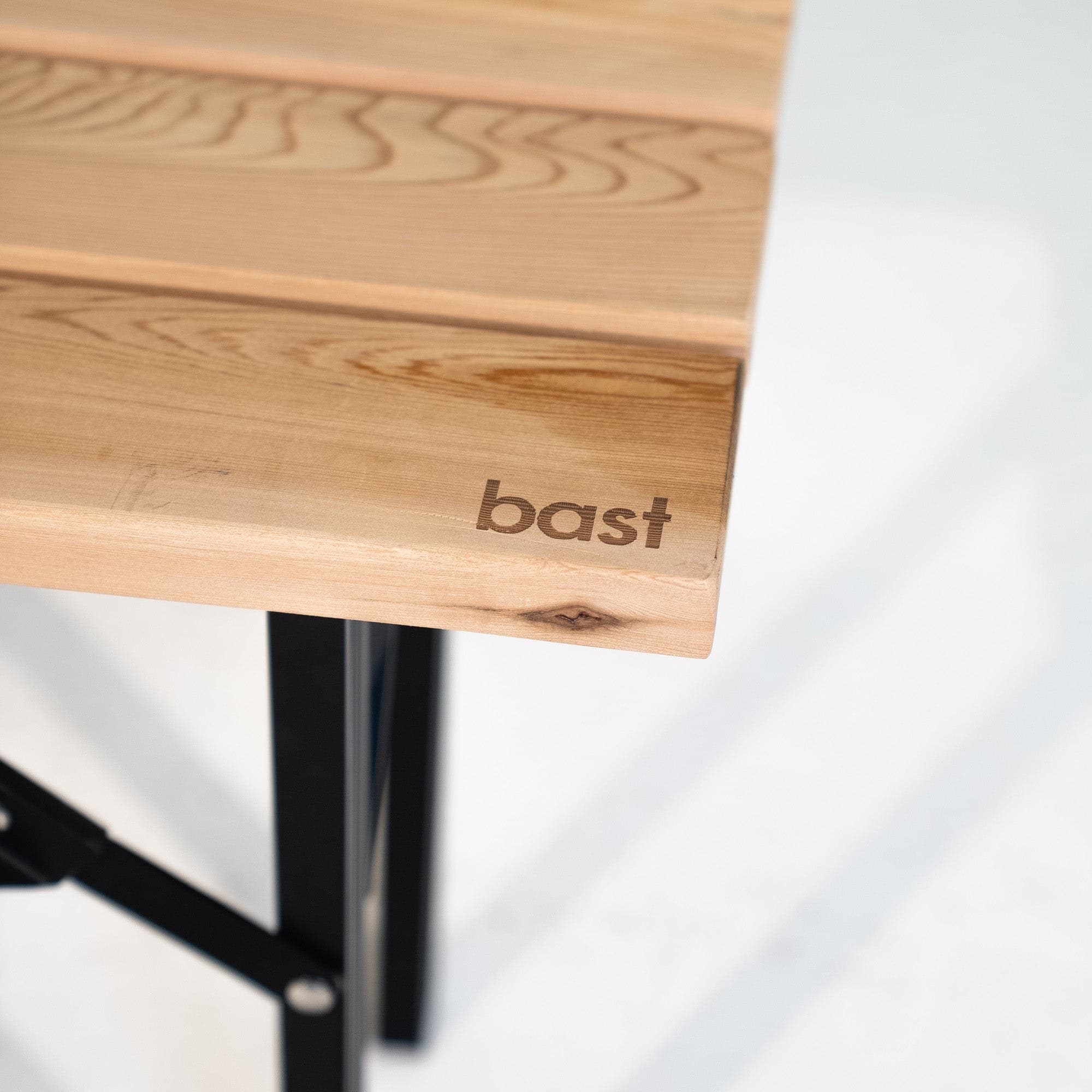 Close-up of the cedar seat with the Bast logo