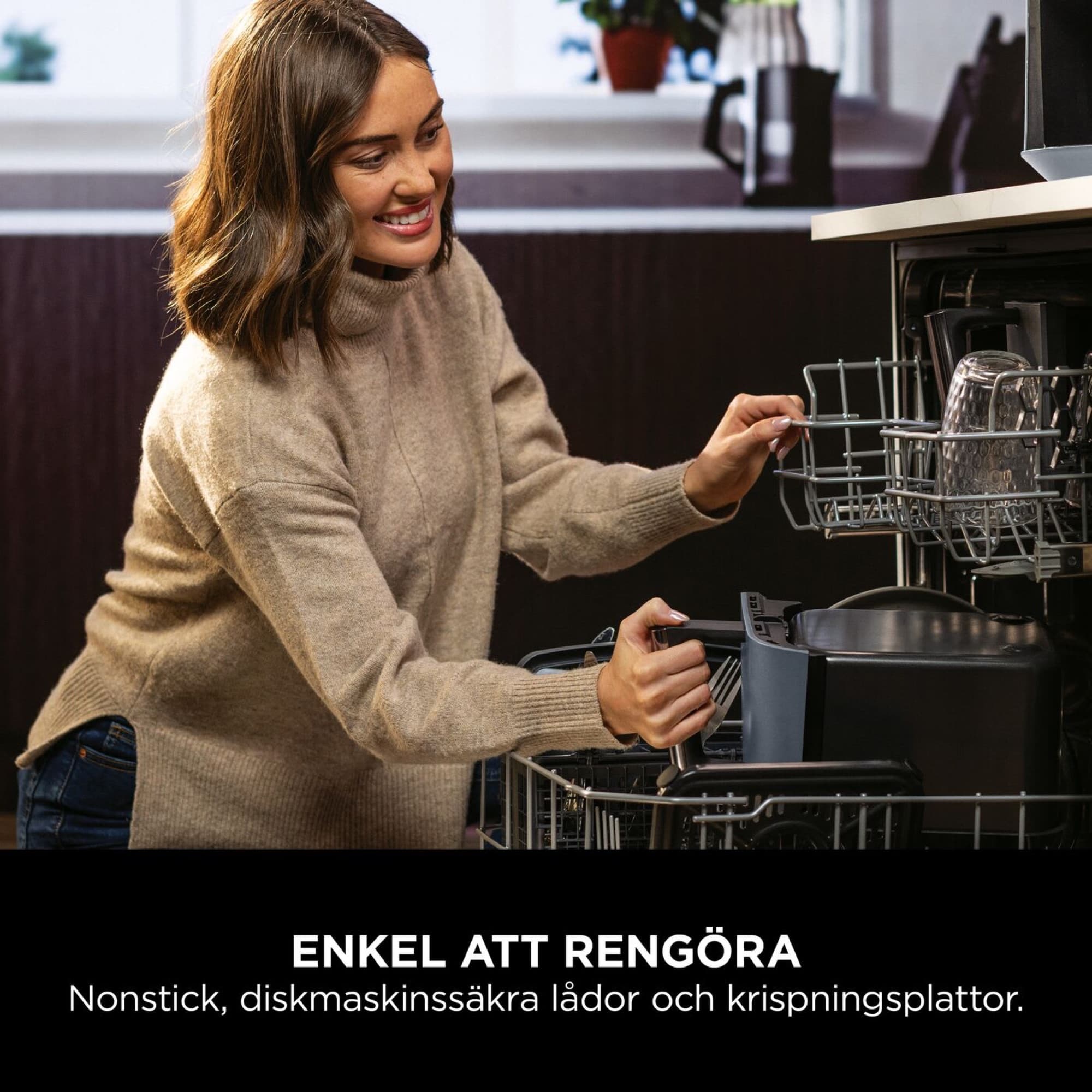 Woman placing a drawer in the dishwasher