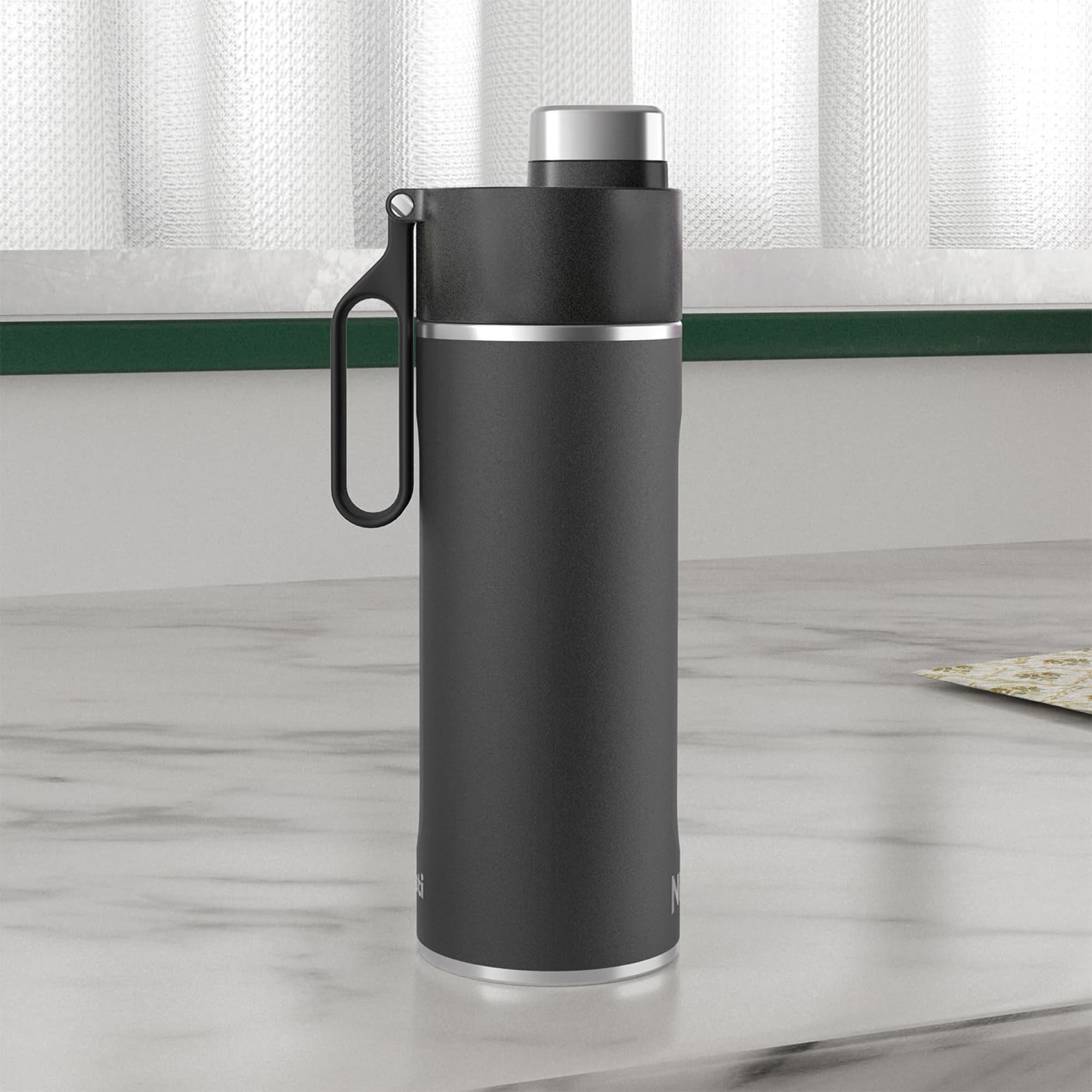The bottle with the handle up