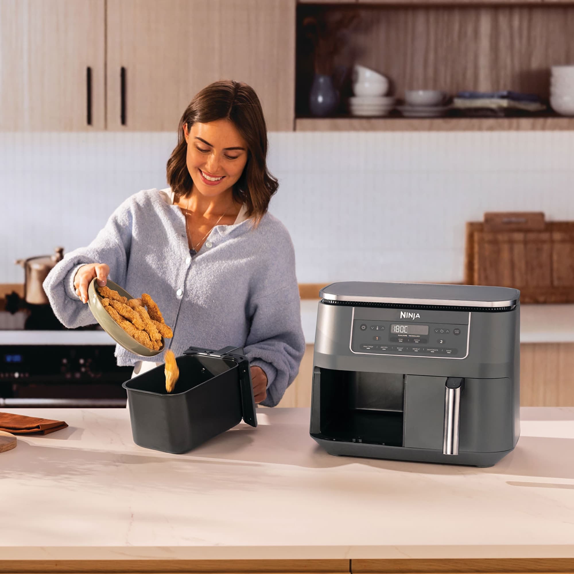 Woman putting chicken into a drawer