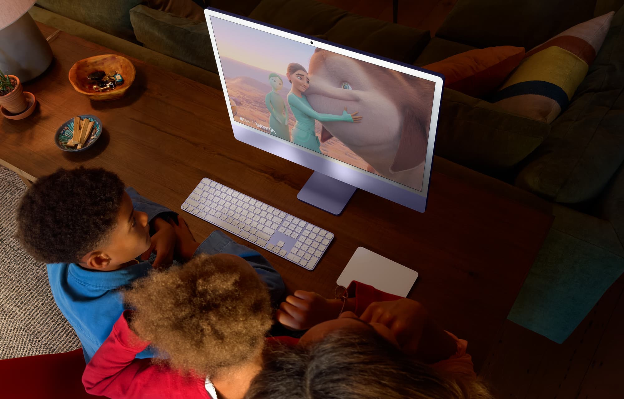A family using iMac at the kitchen table