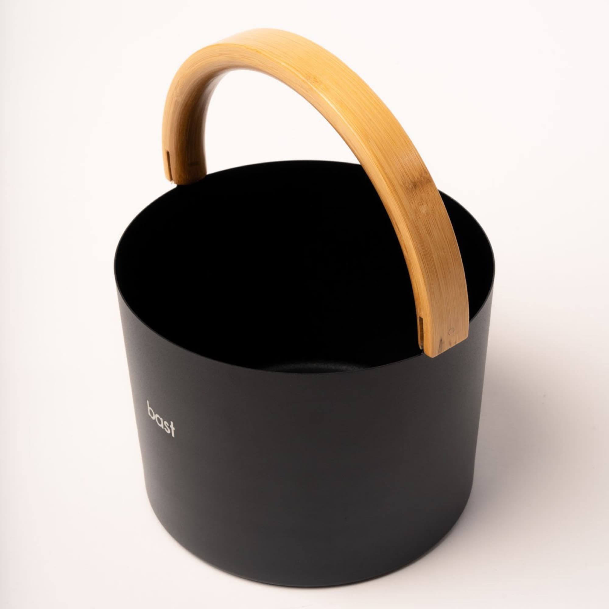 The sauna bucket with its curved bamboo handle