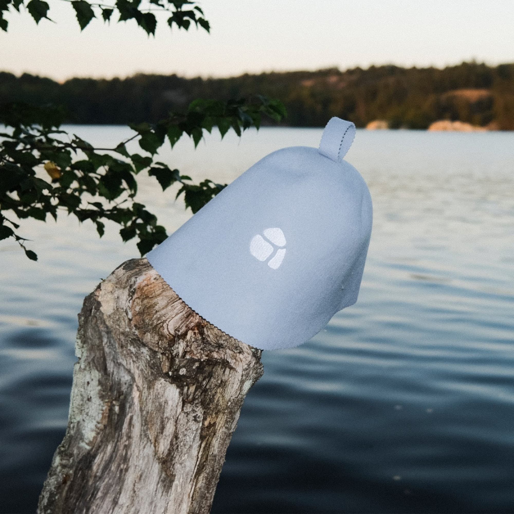 Light blue sauna hat by a lake