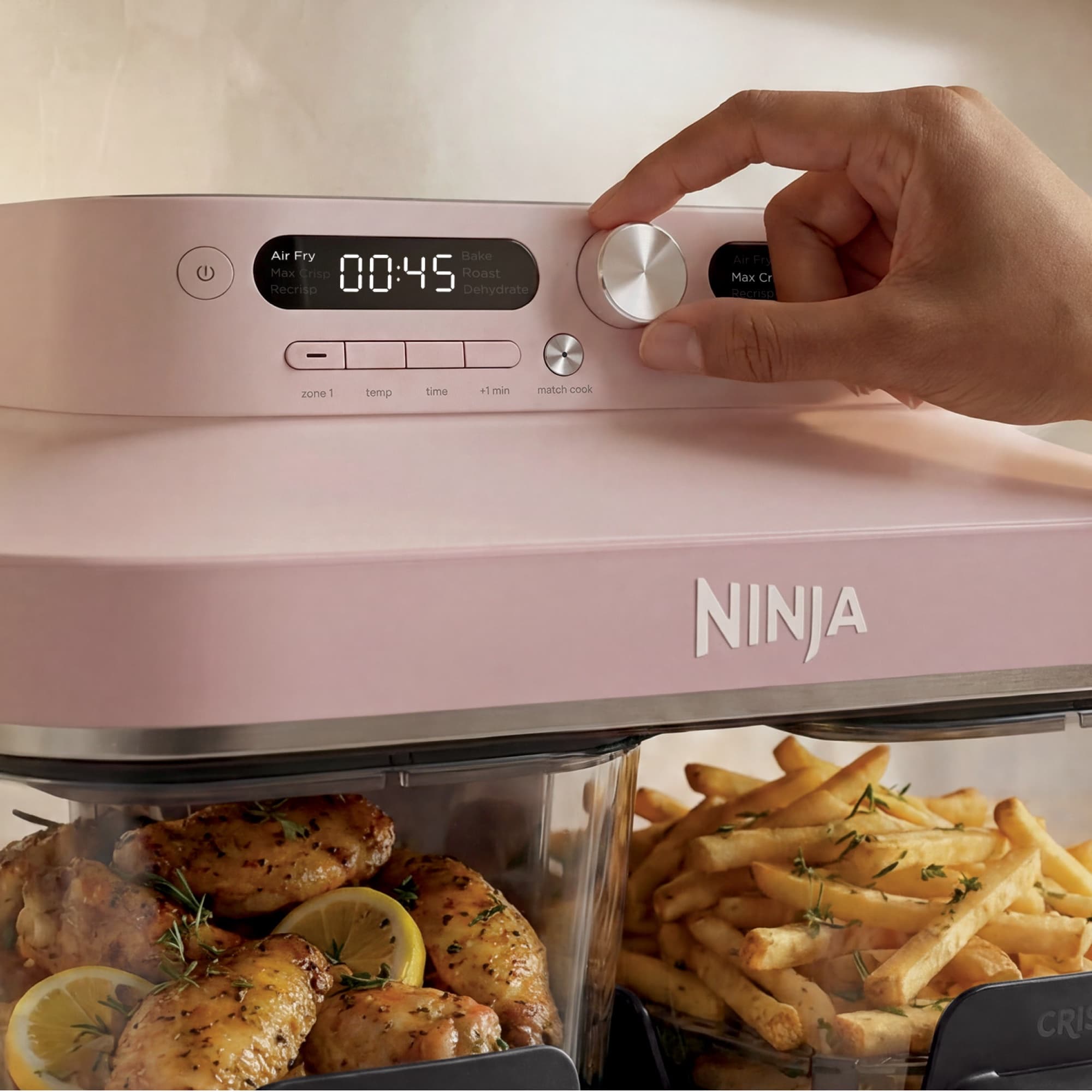 Hand turning the dial, chicken and fries in the glass containers