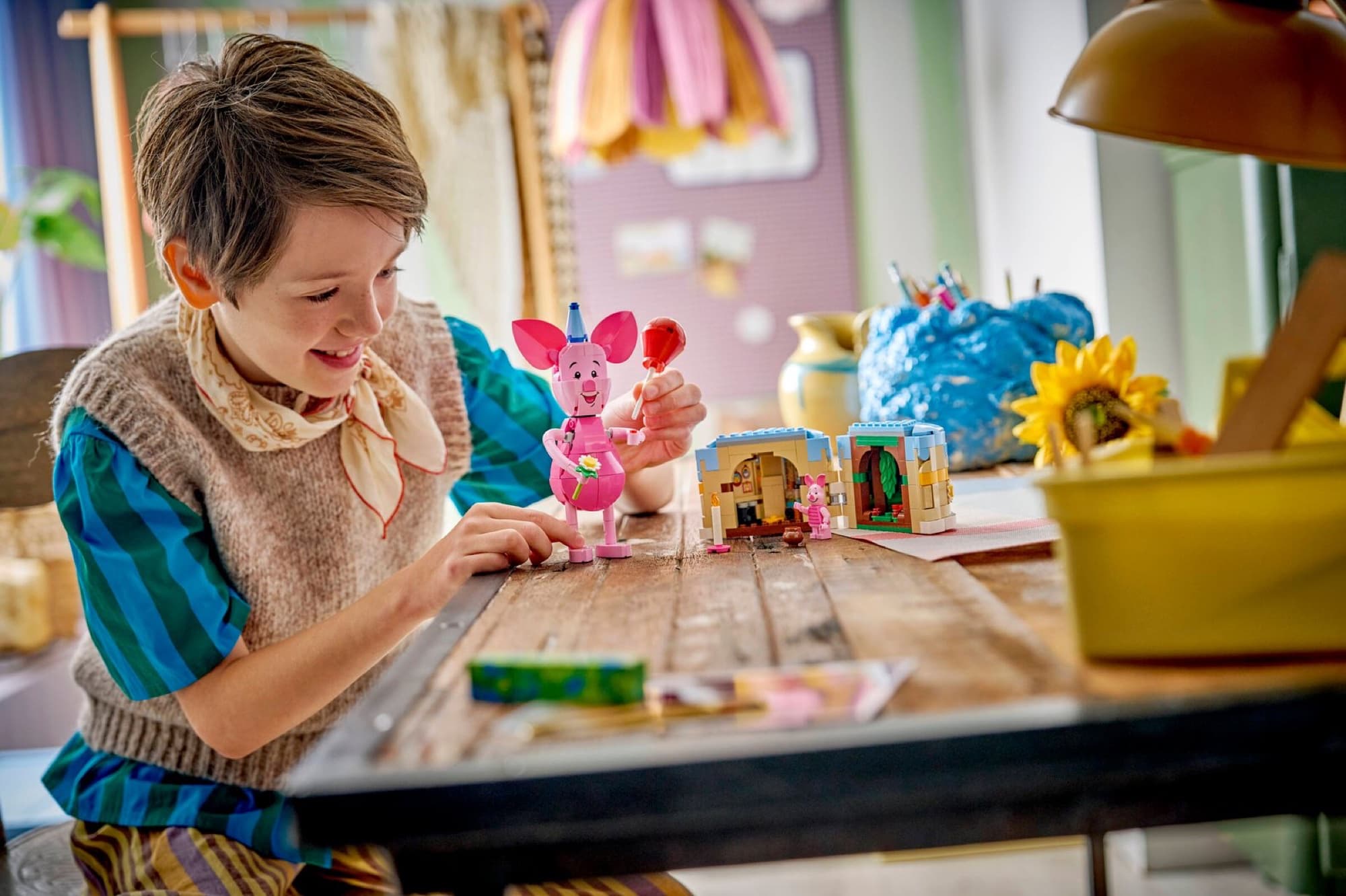 Piglet with birthday cake being built and played with