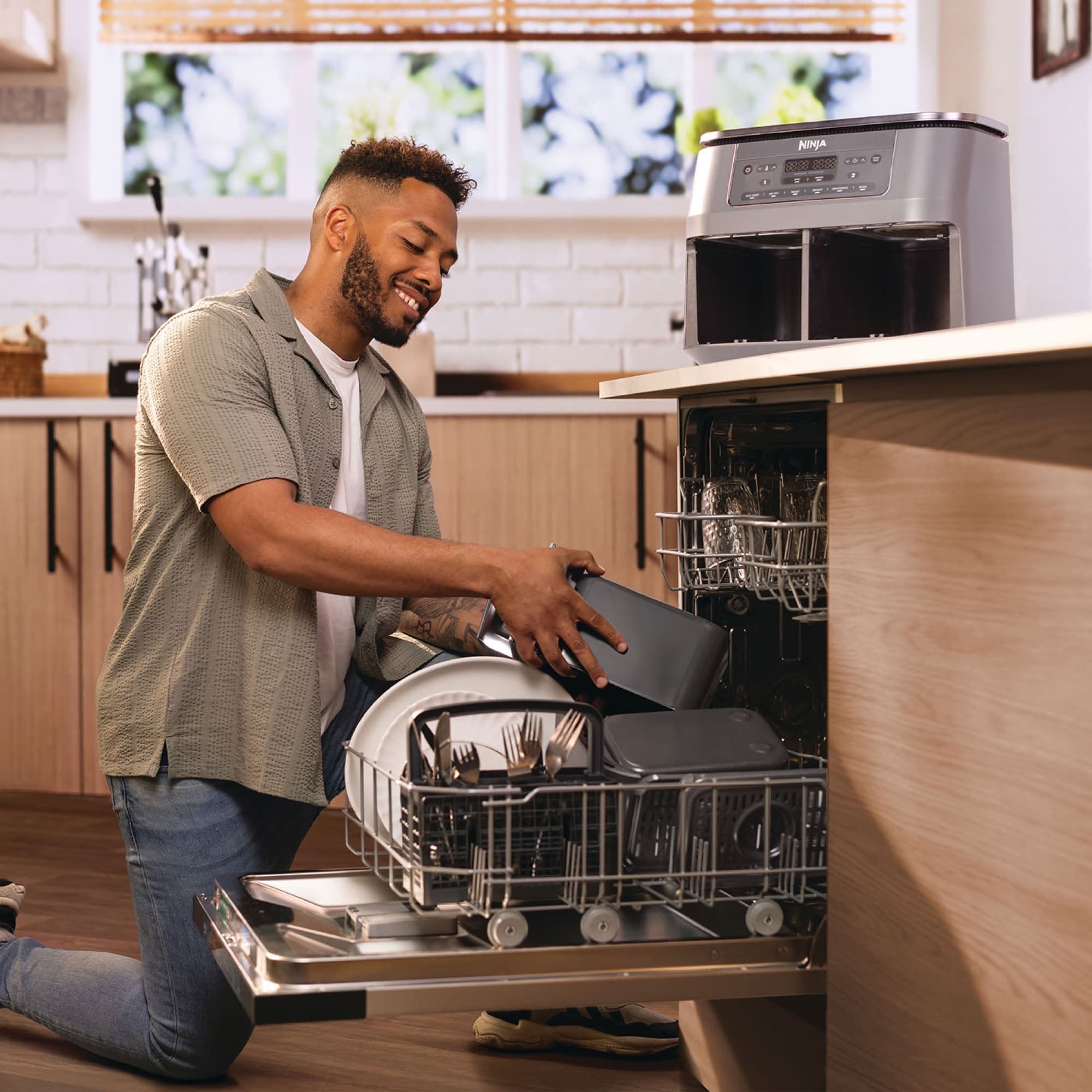 Man placing a drawer in the dishwasher