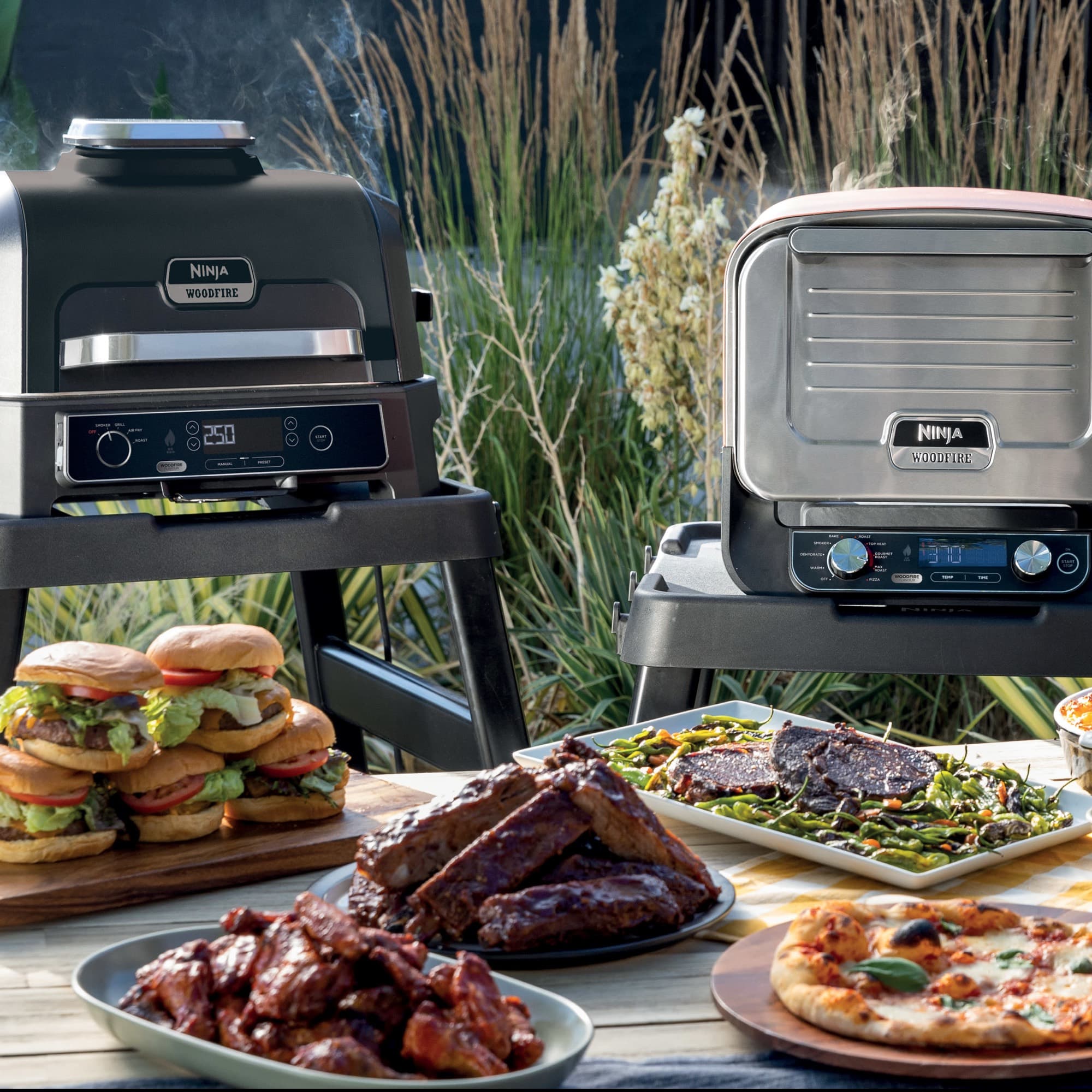 A Woodfire grill and outdoor oven on their stands by a laid table