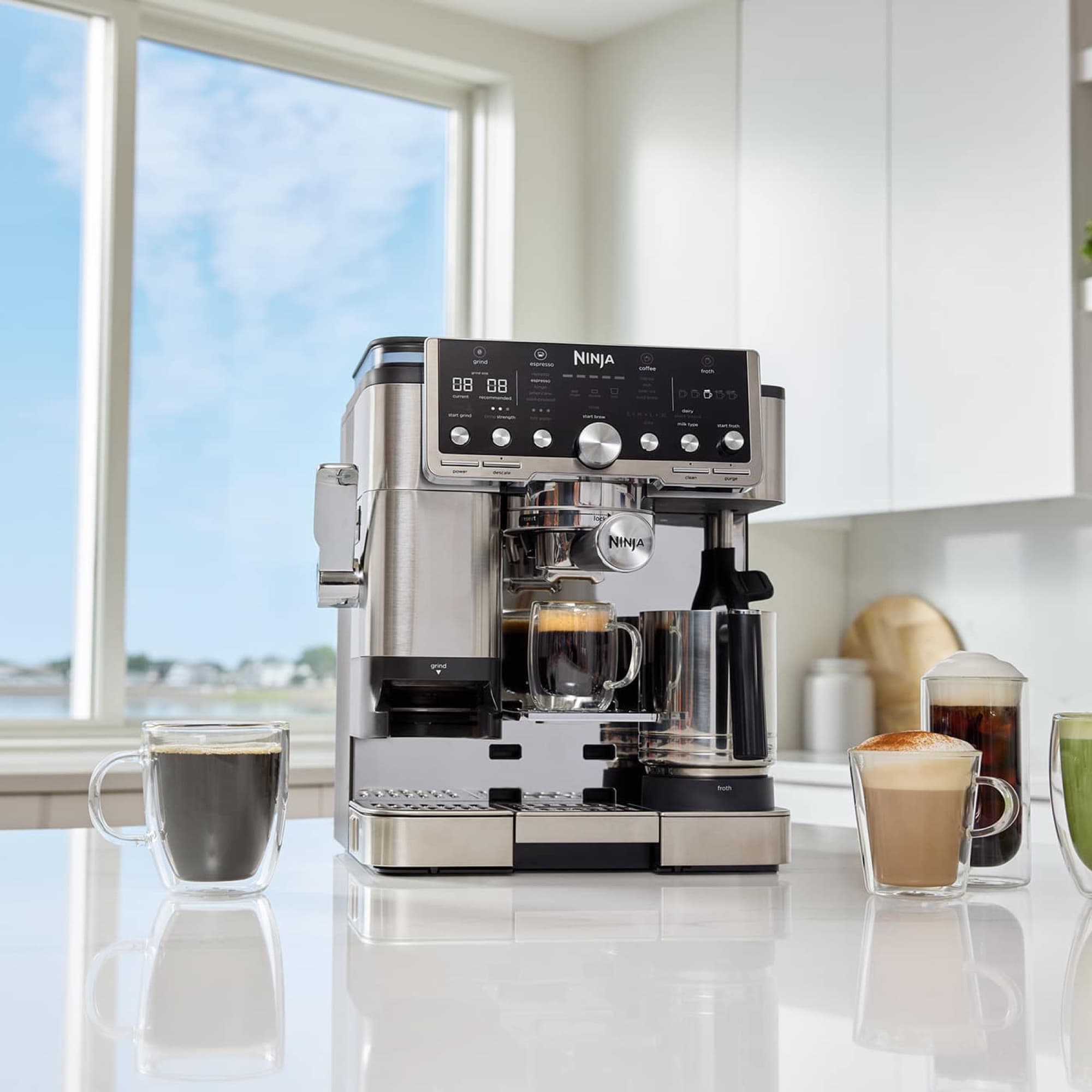 The machine in a bright kitchen with coffee drinks