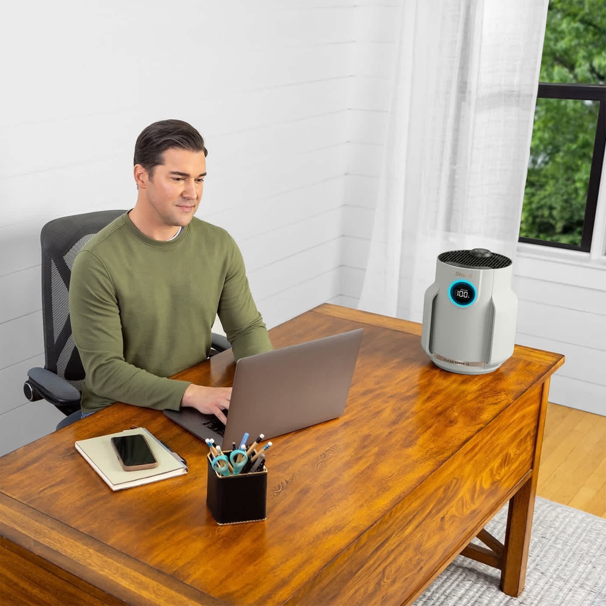 The air purifier on the desk in the home office
