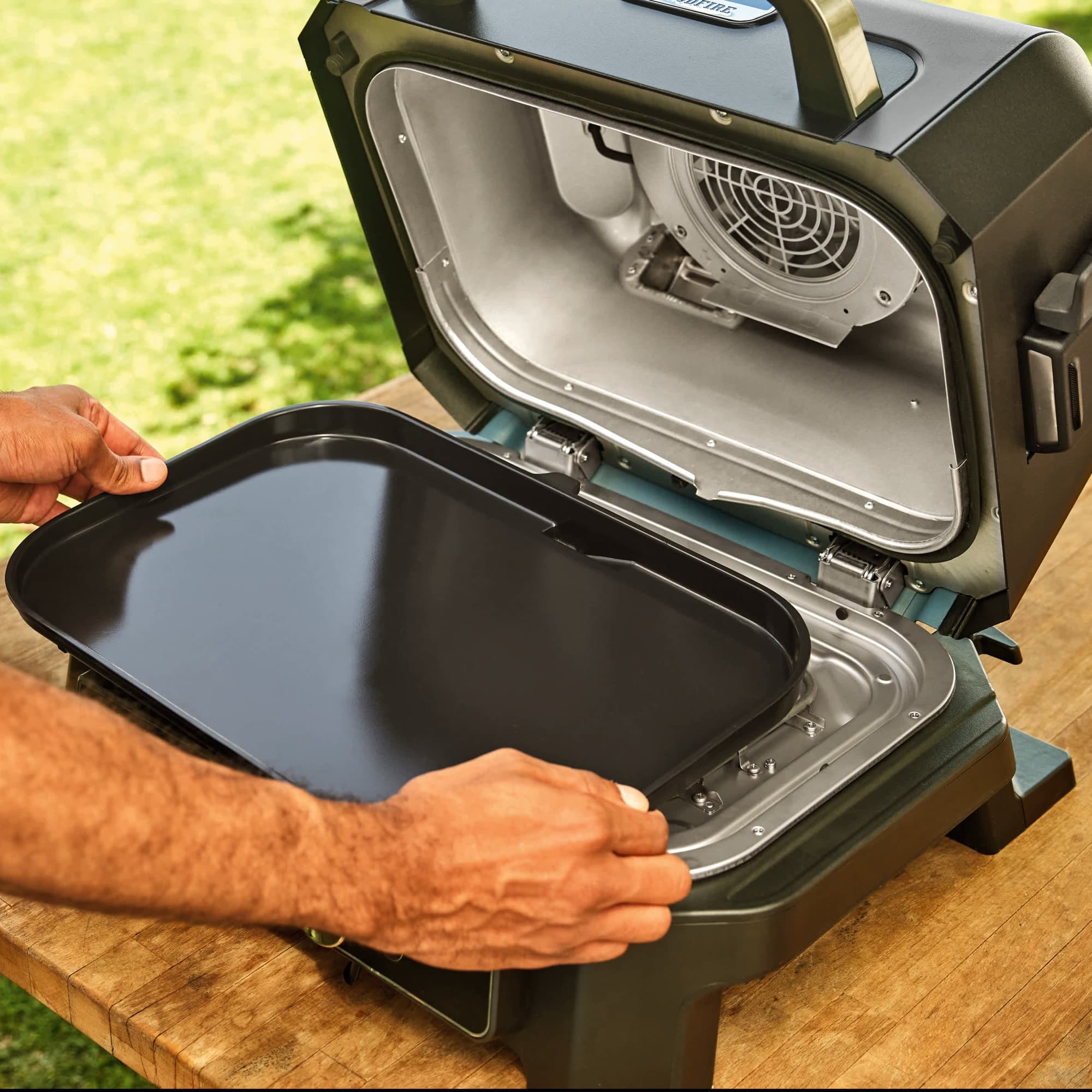 The flat plate being placed in the grill