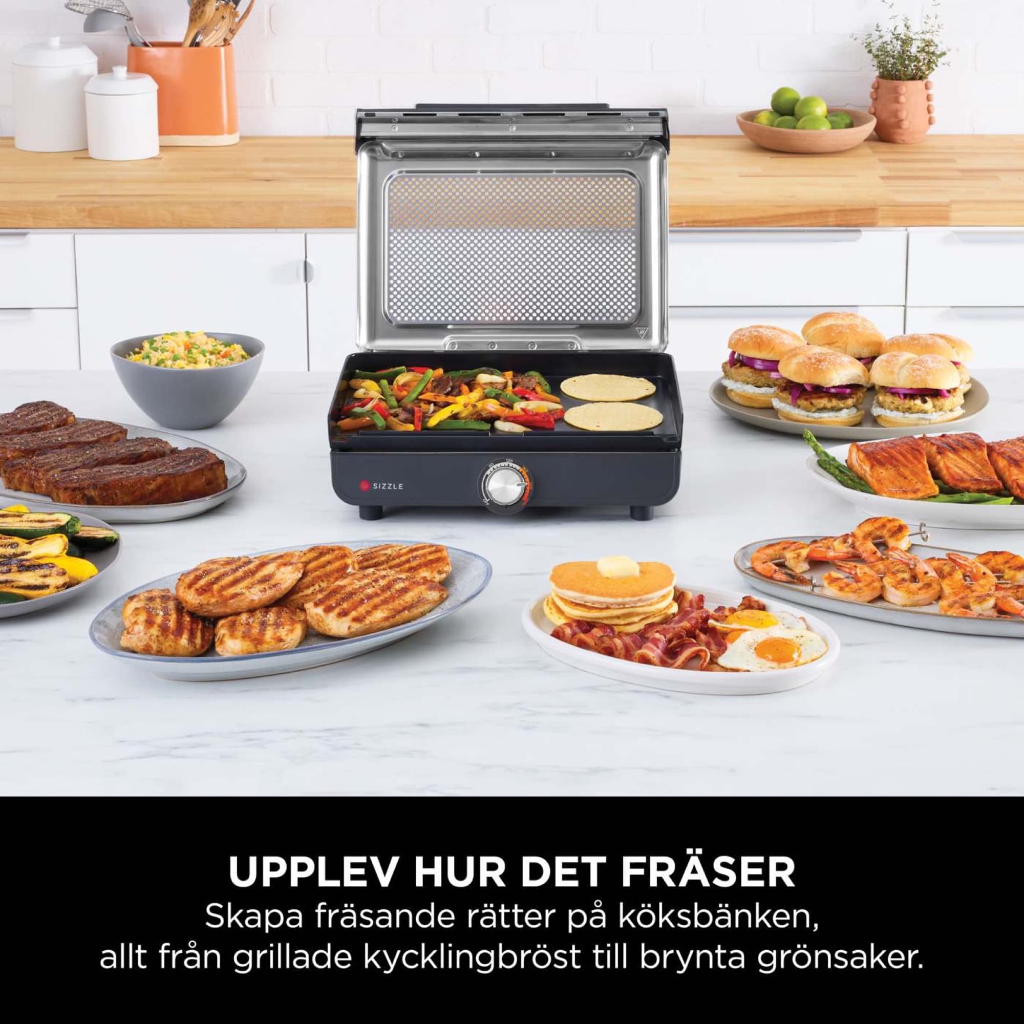 The grill on the worktop with grilled meat, vegetables and pancakes