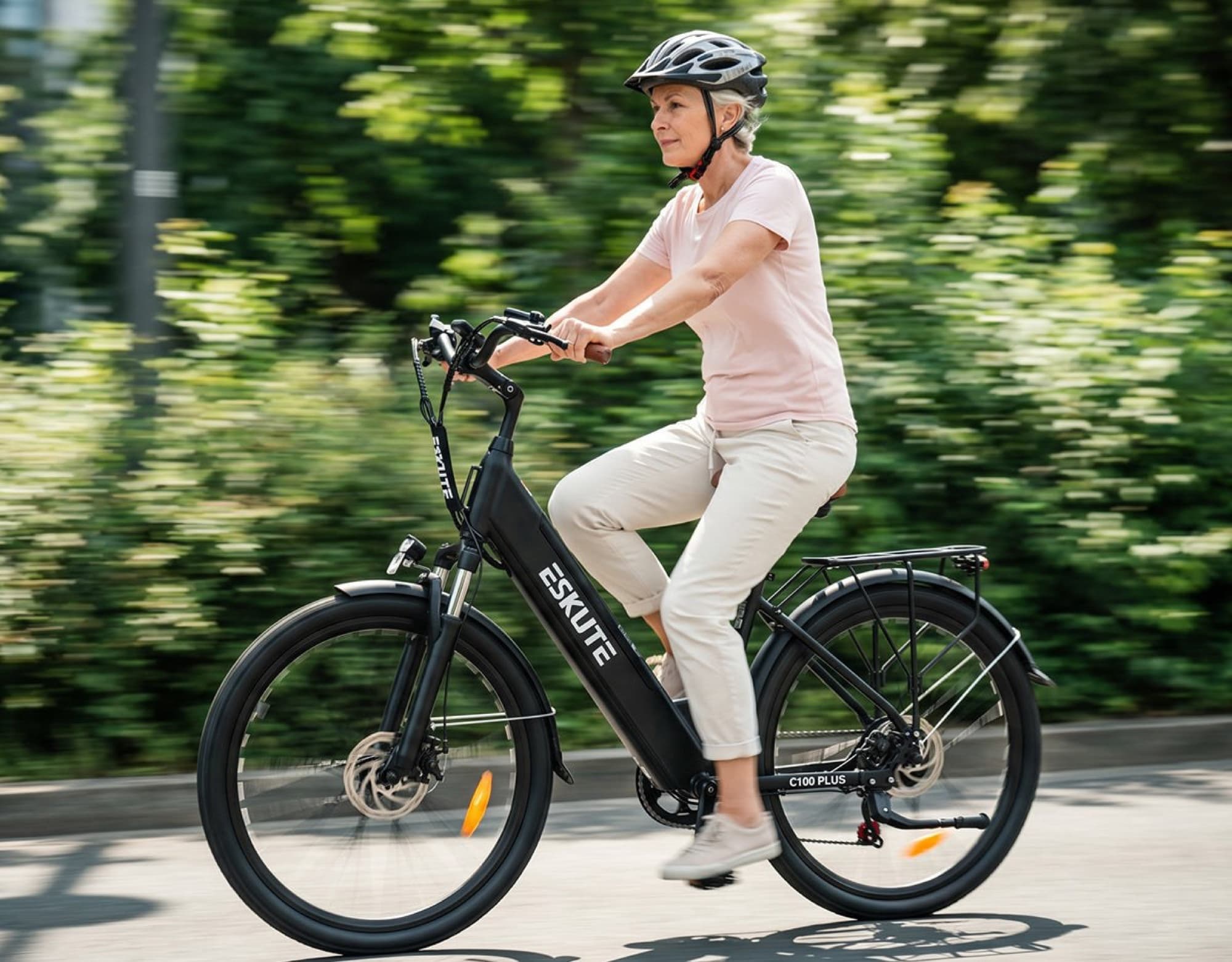 Rider on the Eskute C100 Plus along a street