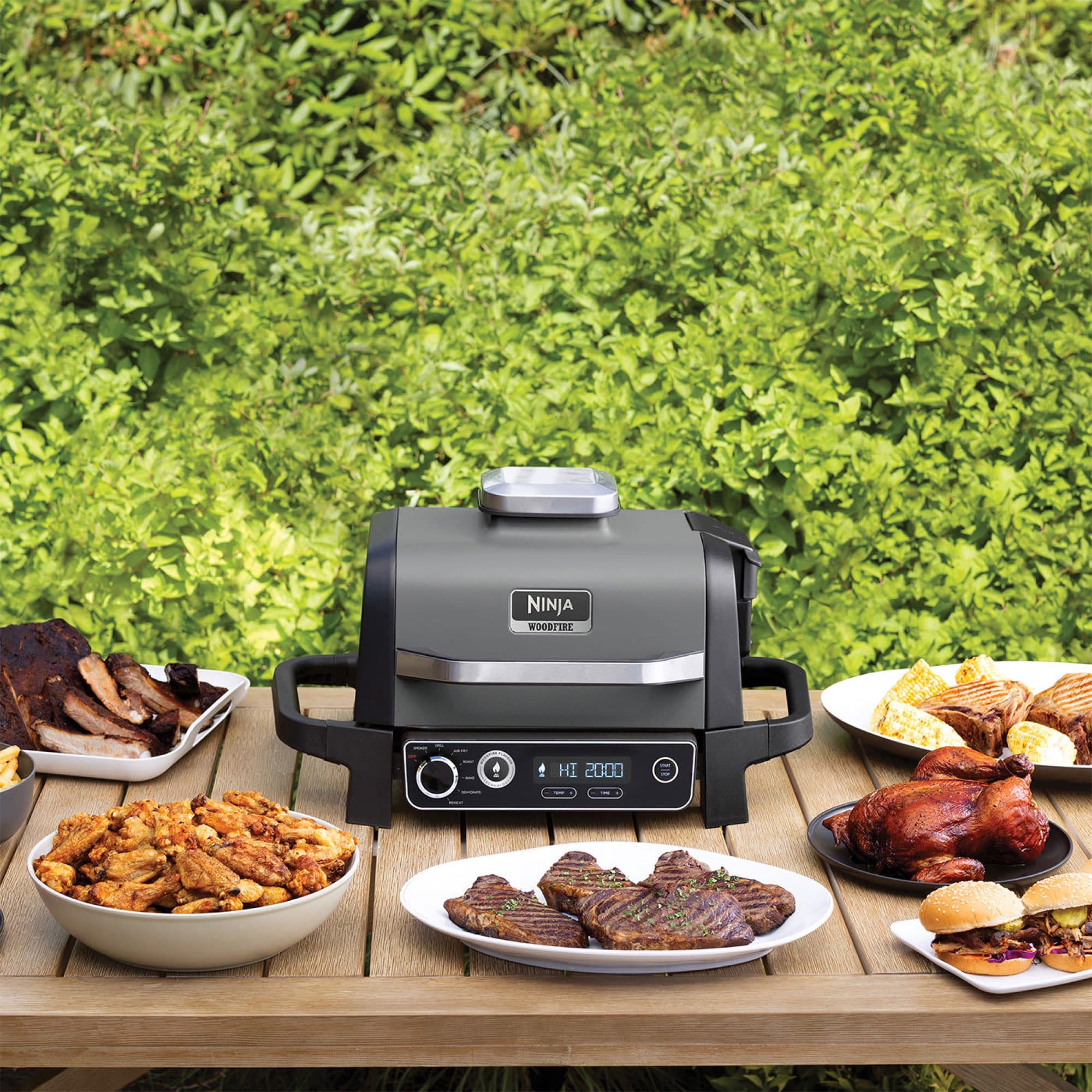 The grill on an outdoor table with grilled food