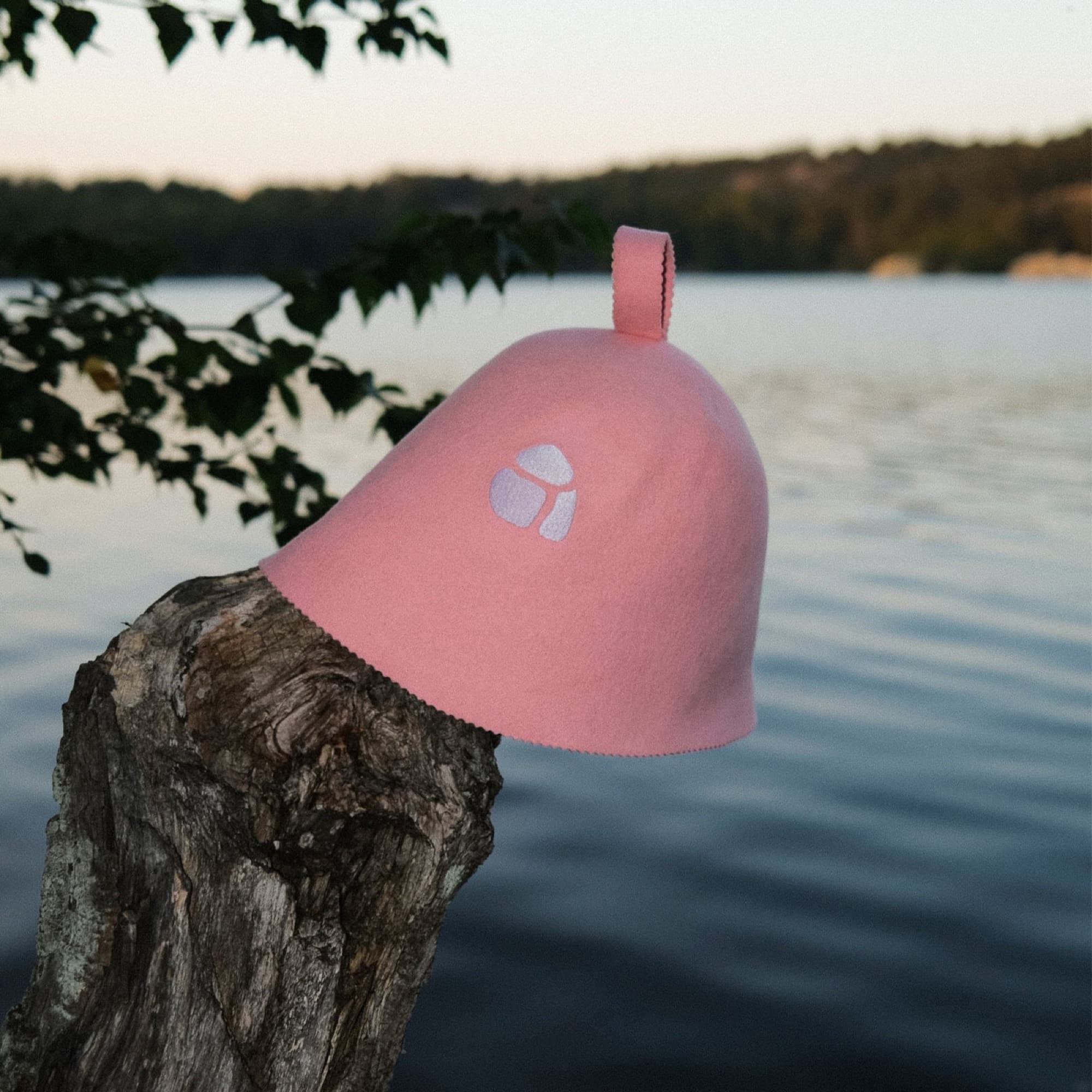 Pink sauna hat by a lake