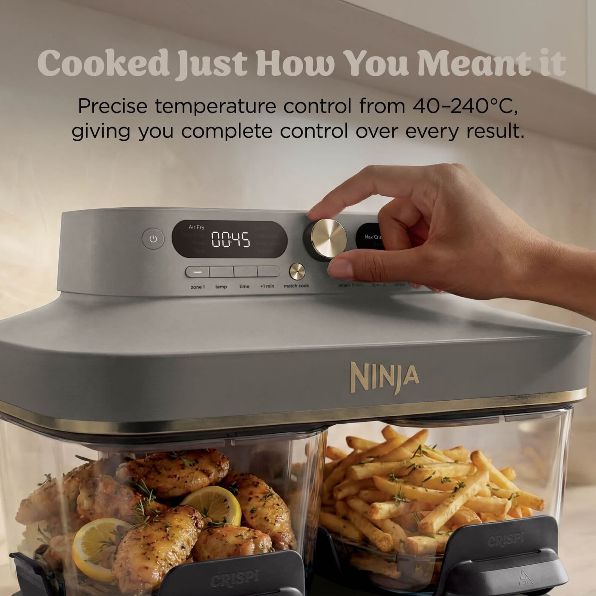 Hand setting the temperature with the dial, chicken and fries in the glass containers