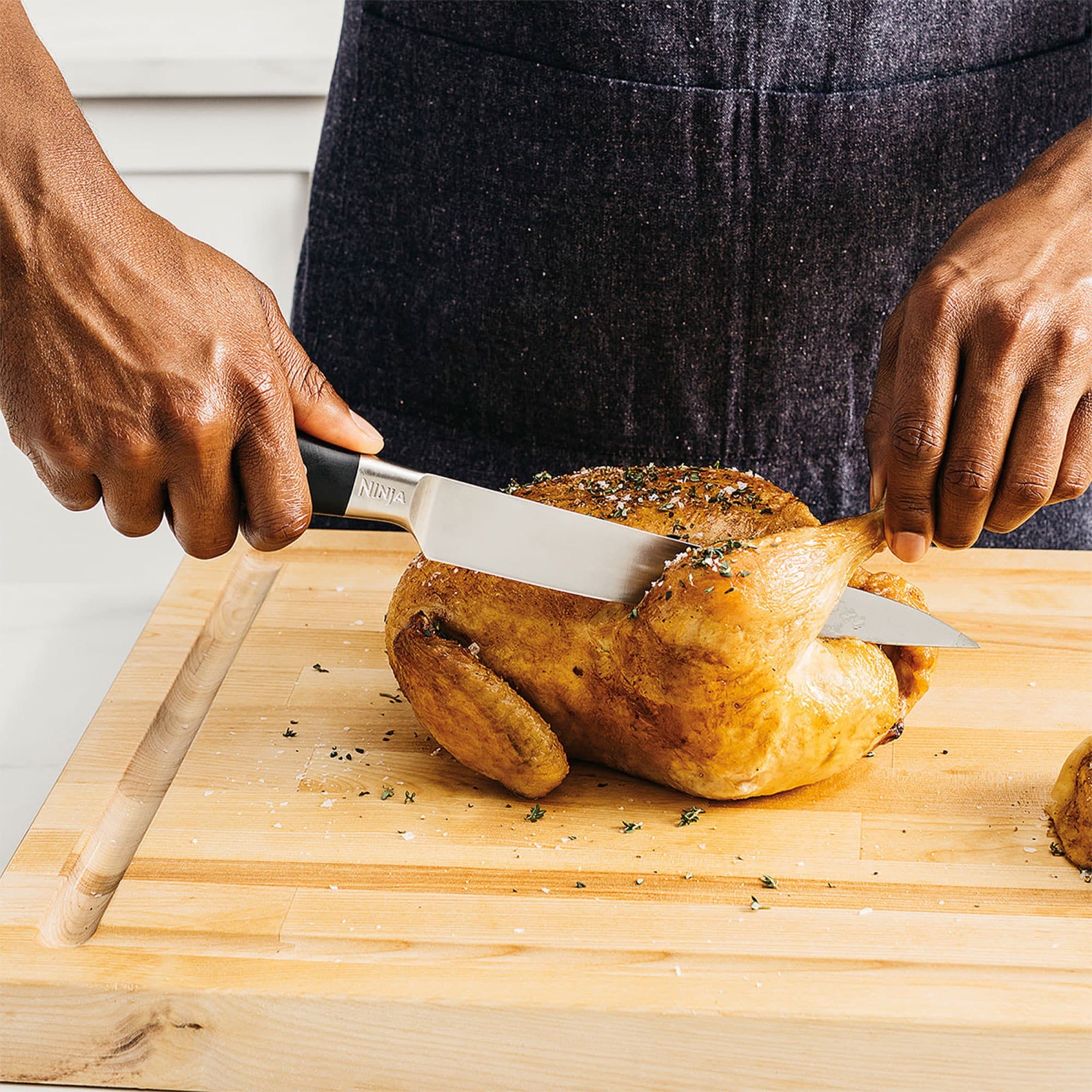 The slicing knife carving a roast chicken