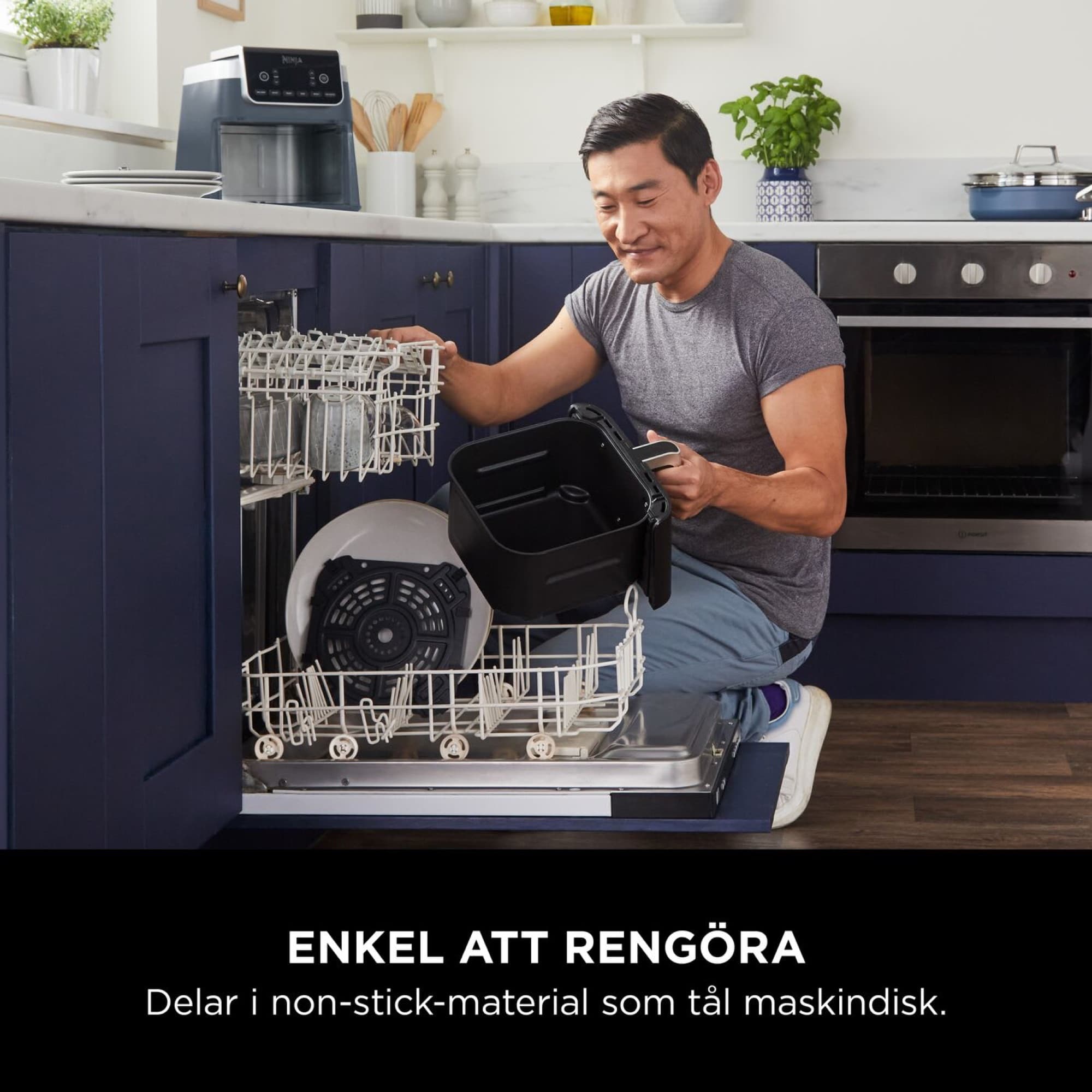 Man placing the drawer in the dishwasher