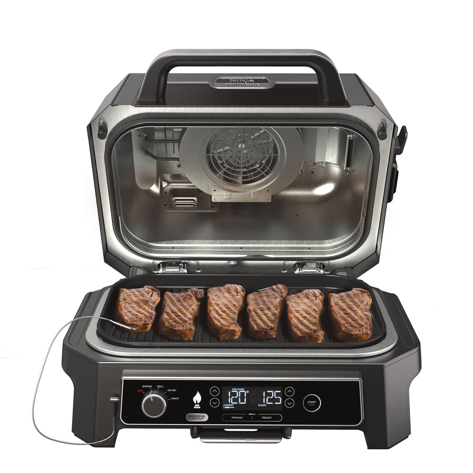 The grill open with steaks on the grill plate