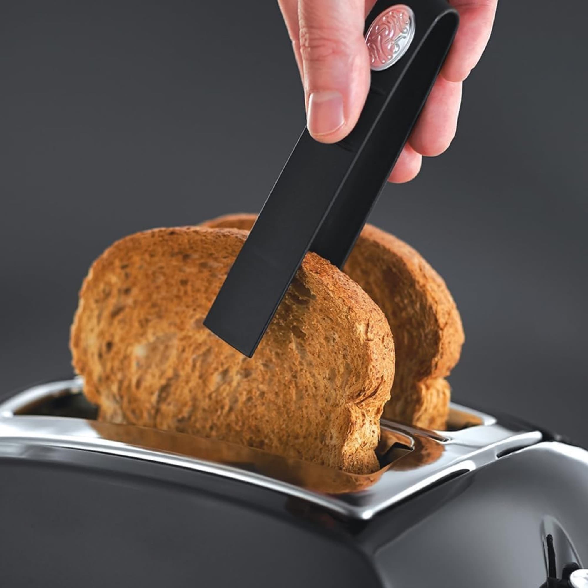 The tongs lift out hot slices