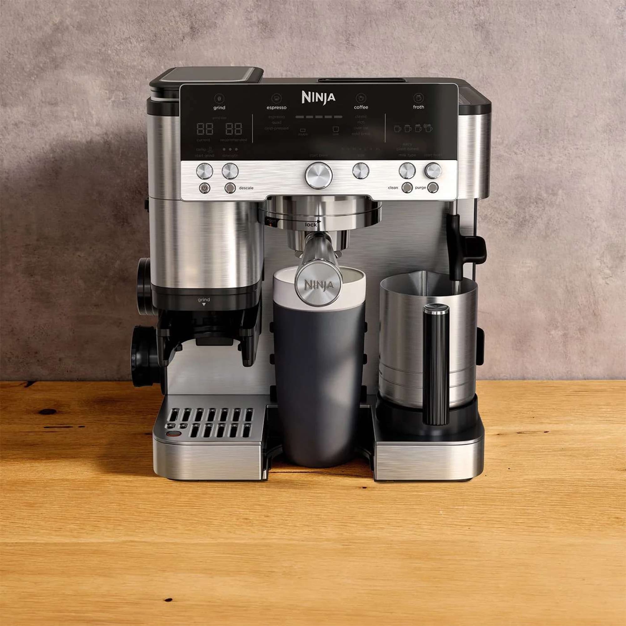 The machine on a wooden worktop with froth jug