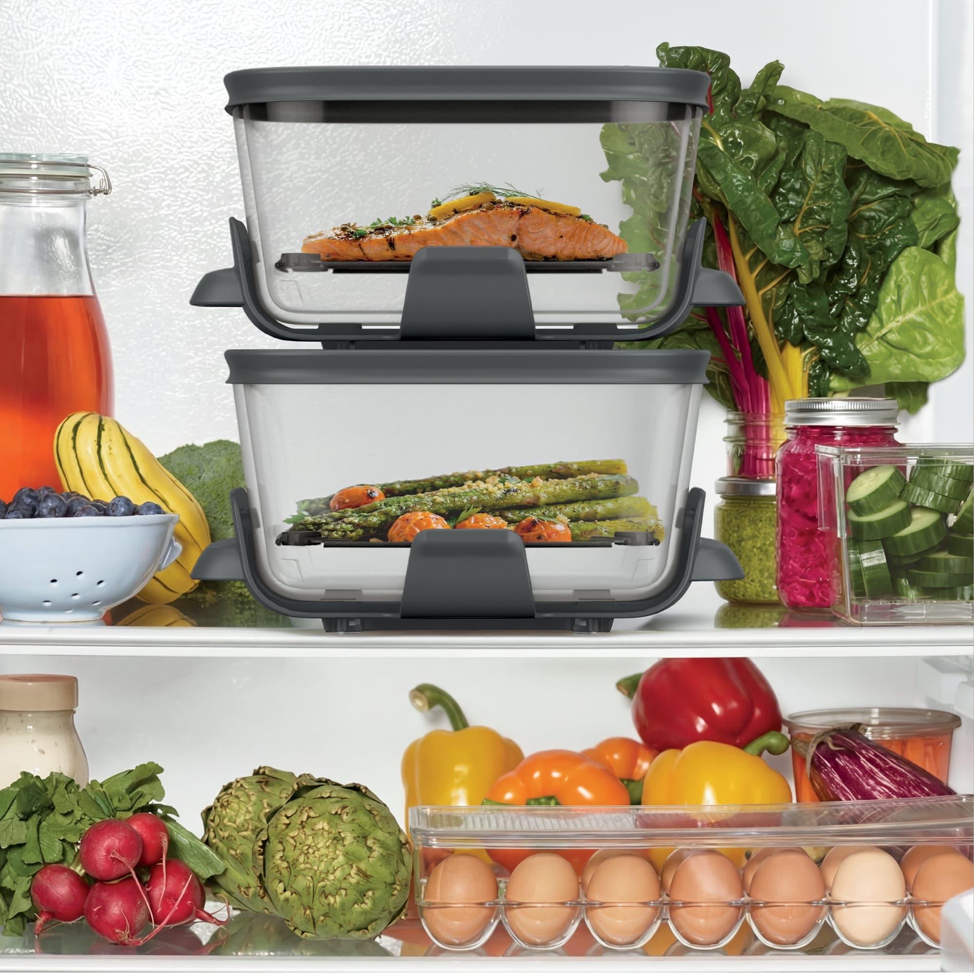 Glass containers with lids and food in the fridge