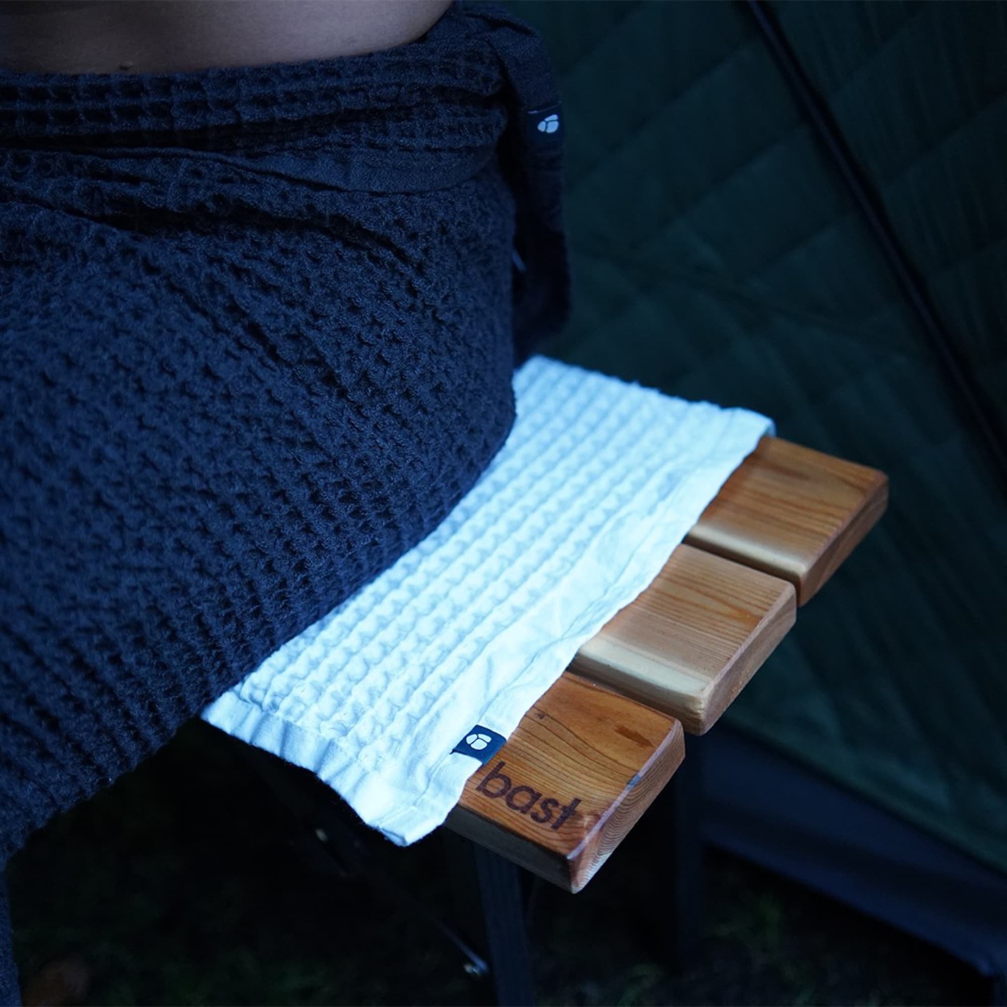 White towel on a cedar sauna bench