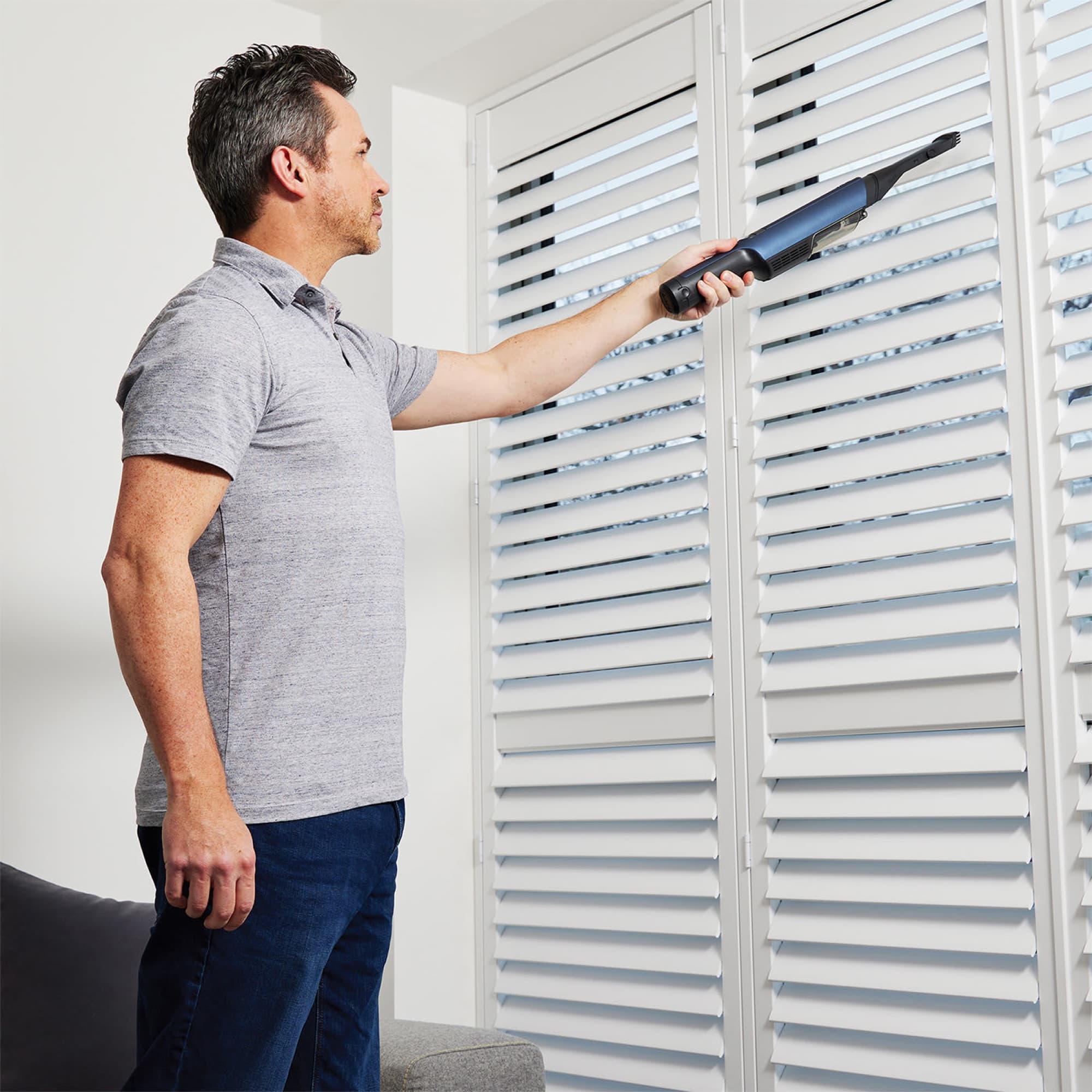 The handheld reaching high up by the shutters