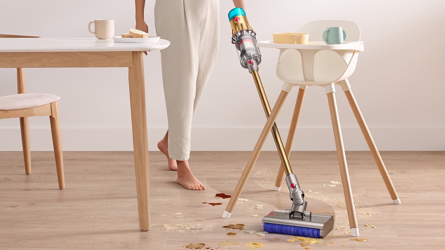 Spills under the high chair being wiped up